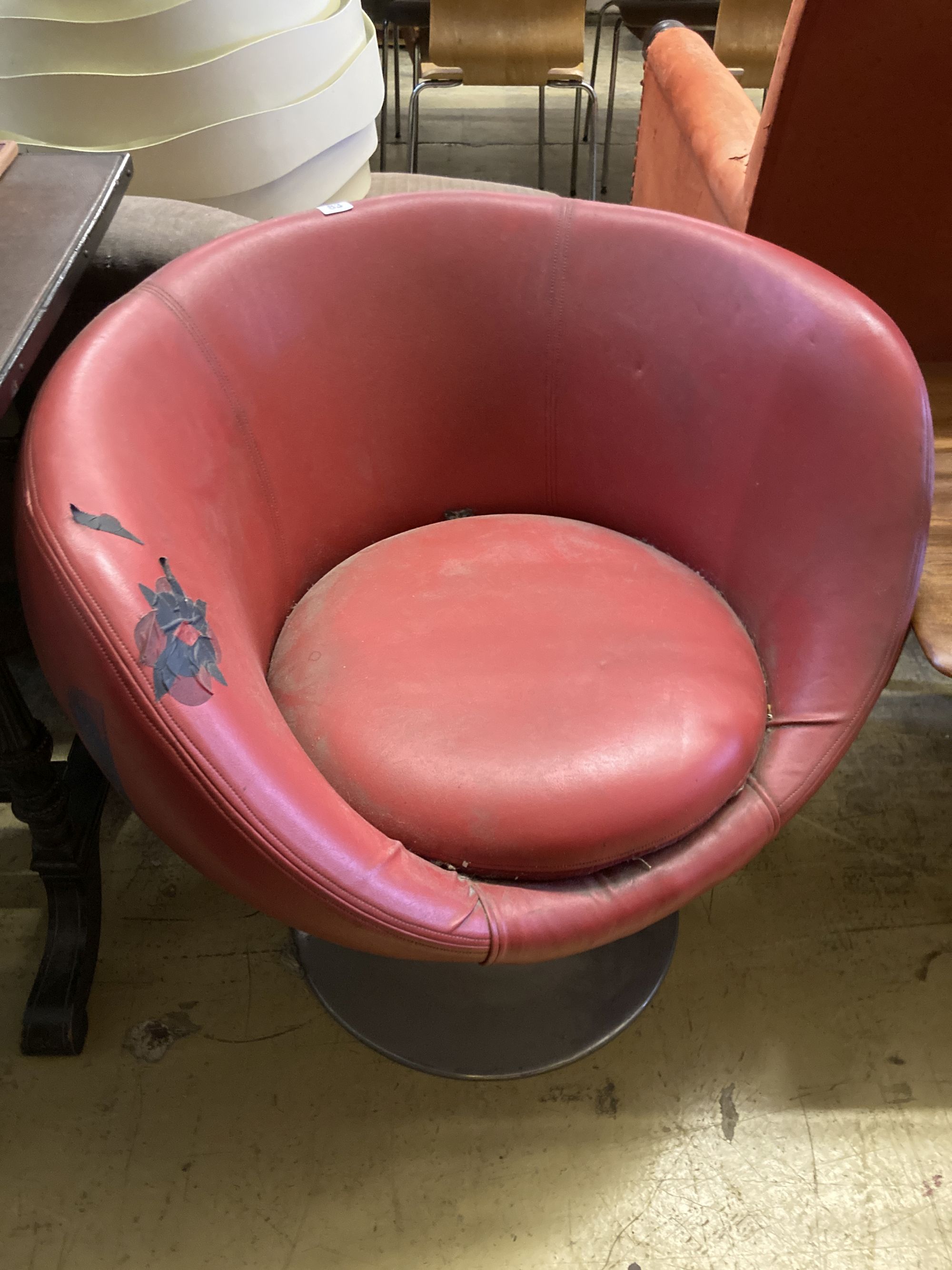 A 1970s red leatherette tub framed swivel chair, width 74cm, depth 64cm, height 74cm